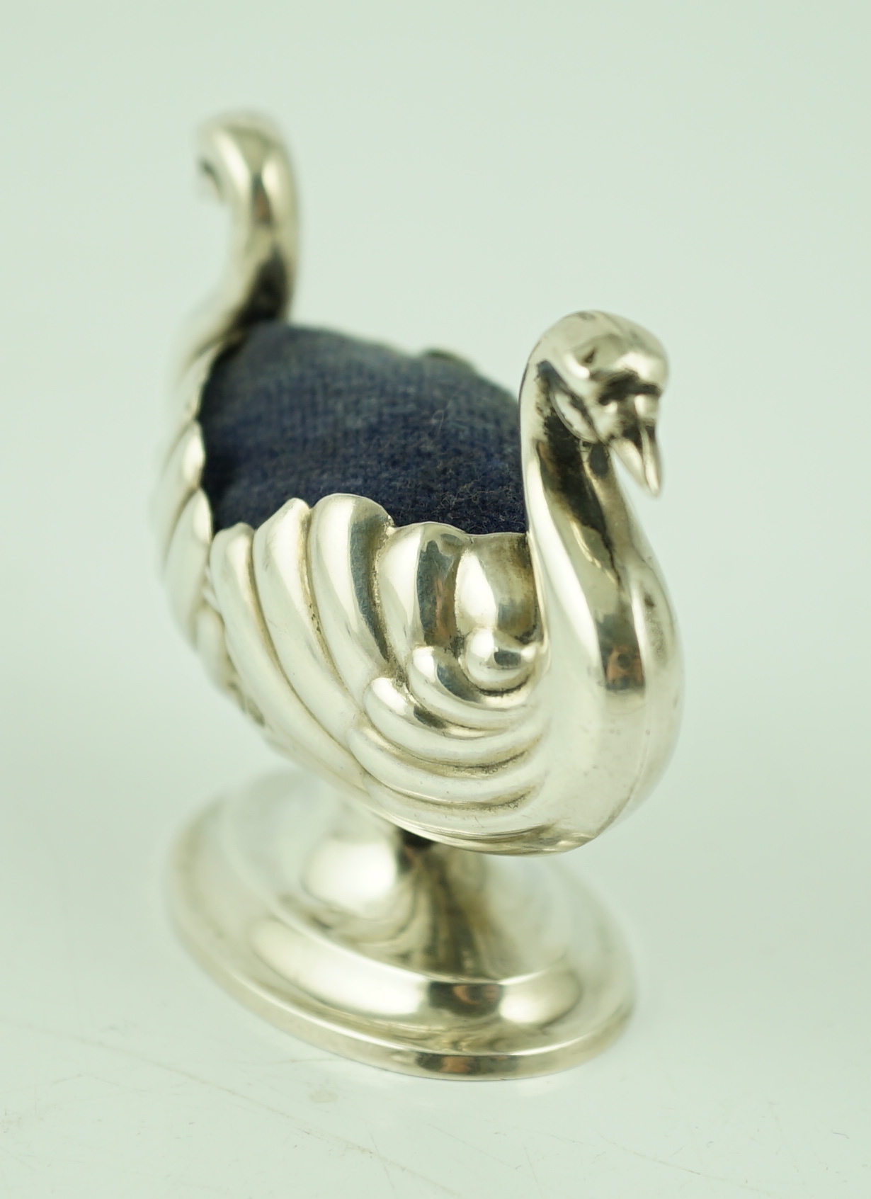 A late Victorian novelty silver pin cushion, modelled as a double headed swan, makers mark rubbed